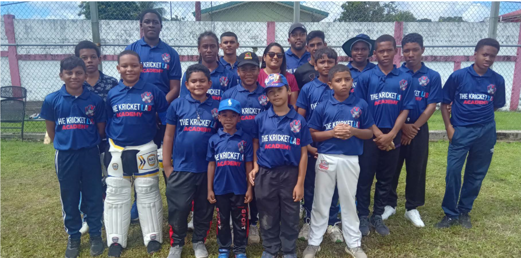 Members of The Kricket Lab Academy with former West Indies women’s spinner Anisa Mohammed at the Ojoe Road Recreation Ground in Sangre Grande. On the left of Mohammed is coach Randy Mahase. - Photo by Stephon Nicholas
